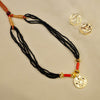 Kolhapuri mangalsutra embedded with gold Lakshmi coins and black beads.