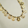 Long gold necklace with Mani beads and Mahalaxmi coin pendants.