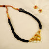 Maharashtrian Tanmani-style mangalsutra with gold pendant and black beads.