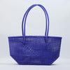 Kalapuri handmade royal blue Koodai tote bag on wooden stool with dried flowers