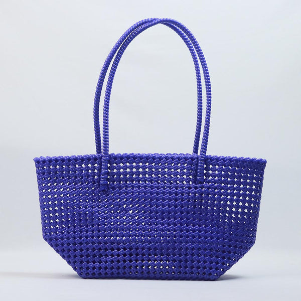 Kalapuri handmade royal blue Koodai tote bag on wooden stool with dried flowers