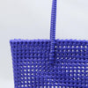 Woman carrying Kalapuri handwoven royal blue Koodai tote bag outdoors