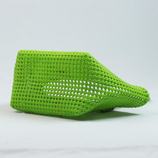 Close-up of woman holding Kalapuri parrot green Koodai tote bag handle