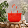 Kalapuri handmade orange Koodai tote bag, front view on plain background