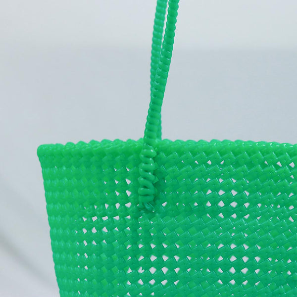 Woman carrying Kalapuri handwoven mint green Koodai tote bag outdoors