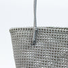 Woman carrying Kalapuri handwoven gray Koodai tote bag outdoors