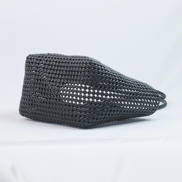 Close-up of woman holding Kalapuri black Koodai tote bag handle