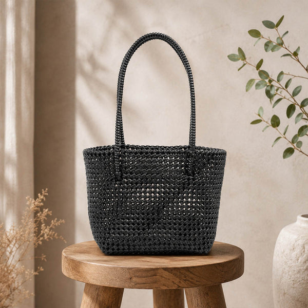 Kalapuri handmade black Koodai tote bag, front view on plain background