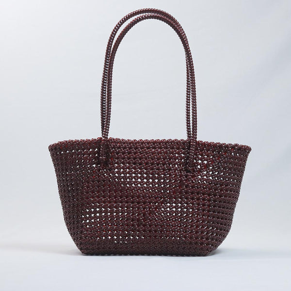 Kalapuri handmade maroon Koodai tote bag on wooden stool with dried flowers