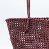 Woman carrying Kalapuri handwoven maroon Koodai tote bag outdoors