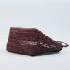 Close-up of woman holding Kalapuri maroon Koodai tote bag handle