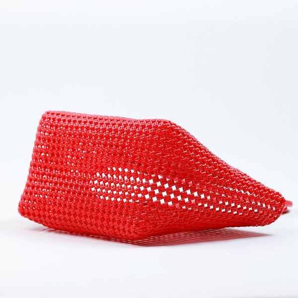 Close-up of woman holding Kalapuri red Koodai tote bag handle