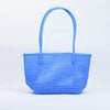 Kalapuri handmade cornflower blue Koodai tote bag on wooden stool with dried flowers