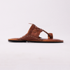 Brown sandal with black sole on a white background