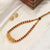 Gold Bead Necklace with Red Accents