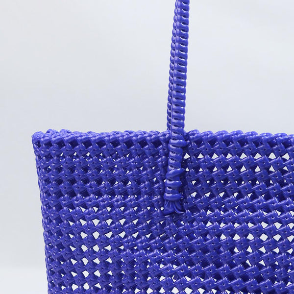 Woman carrying Kalapuri handwoven royal blue Koodai tote bag outdoors