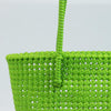 Woman carrying Kalapuri handwoven parrot green Koodai tote bag outdoors