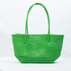 Kalapuri handmade bright green Koodai tote bag on wooden stool with dried flowers