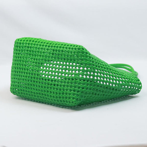 Close-up of woman holding Kalapuri bright green Koodai tote bag handle