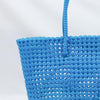 Woman carrying Kalapuri handwoven sky blue Koodai tote bag outdoors