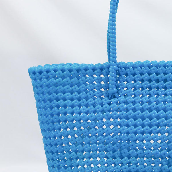 Woman carrying Kalapuri handwoven sky blue Koodai tote bag outdoors