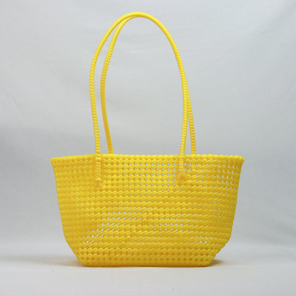 Kalapuri handmade yellow Koodai tote bag on wooden stool with dried flowers