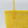 Woman carrying Kalapuri handwoven yellow Koodai tote bag outdoors