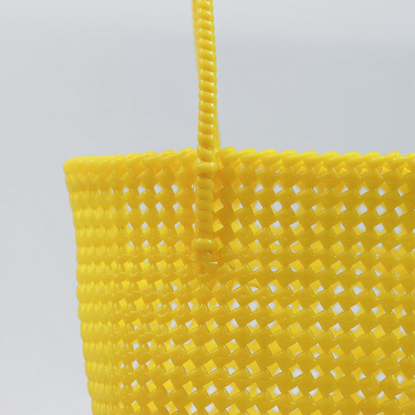 Woman carrying Kalapuri handwoven yellow Koodai tote bag outdoors