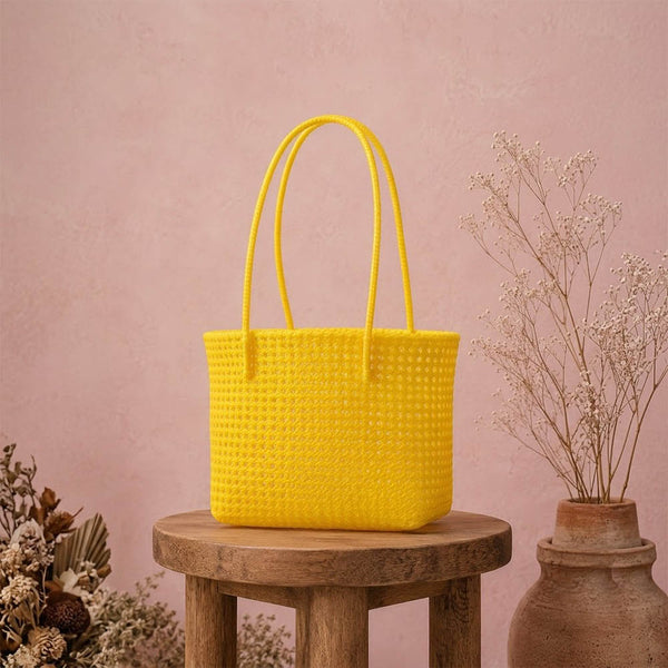 Kalapuri handmade yellow Koodai tote bag, front view on plain background