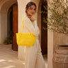 Close-up of handwoven handle detail on Kalapuri yellow Koodai tote bag