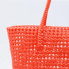 Woman carrying Kalapuri handwoven orange Koodai tote bag outdoors