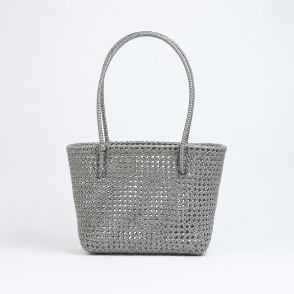Kalapuri handmade gray Koodai tote bag on wooden stool with dried flowers