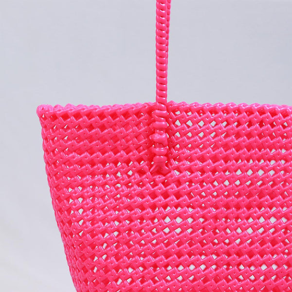 Woman carrying Kalapuri handwoven pink Koodai tote bag outdoors
