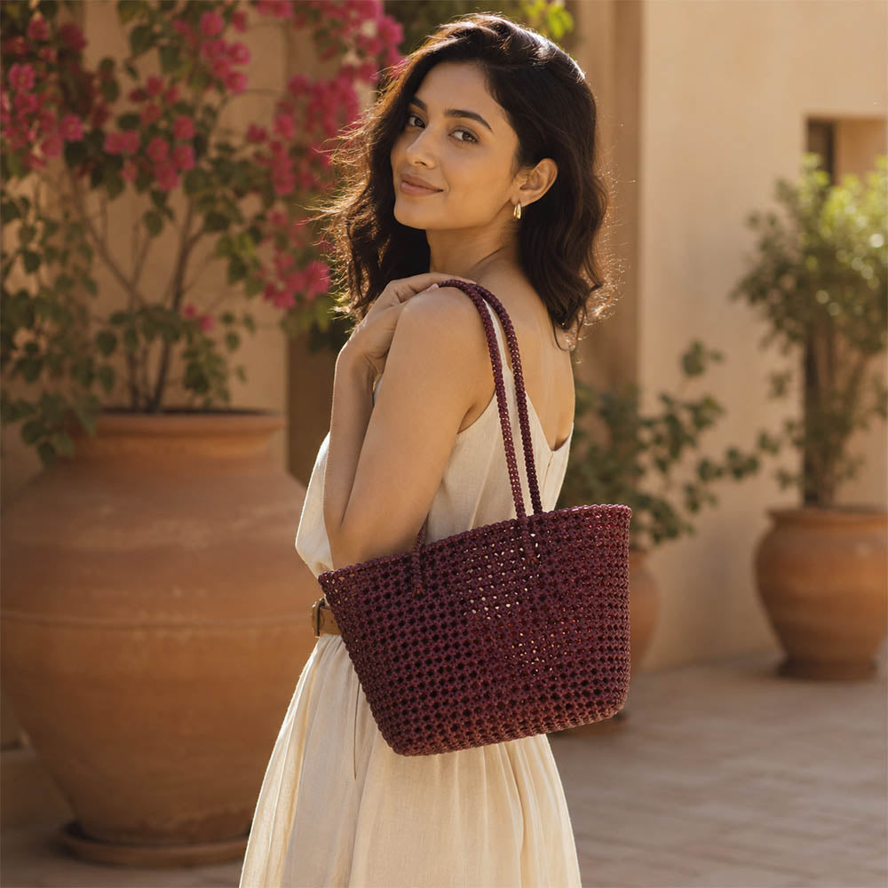 Close-up of handwoven handle detail on Kalapuri maroon Koodai tote bag