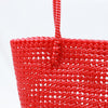 Woman carrying Kalapuri handwoven red Koodai tote bag outdoors