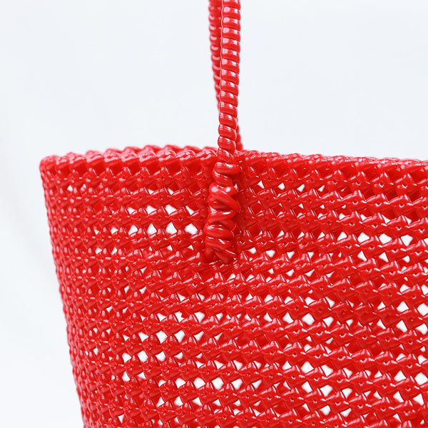 Woman carrying Kalapuri handwoven red Koodai tote bag outdoors