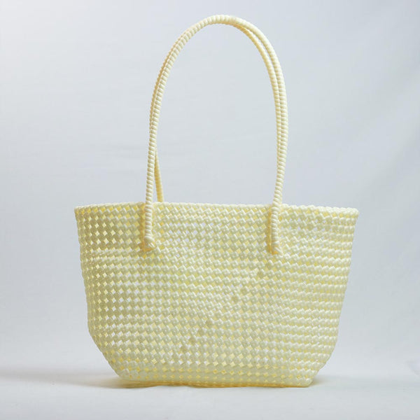 Kalapuri handmade cream Koodai tote bag on wooden stool with dried flowers