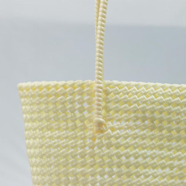 Woman carrying Kalapuri handwoven cream Koodai tote bag outdoors