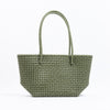 Kalapuri handmade olive green Koodai tote bag on wooden stool with dried flowers
