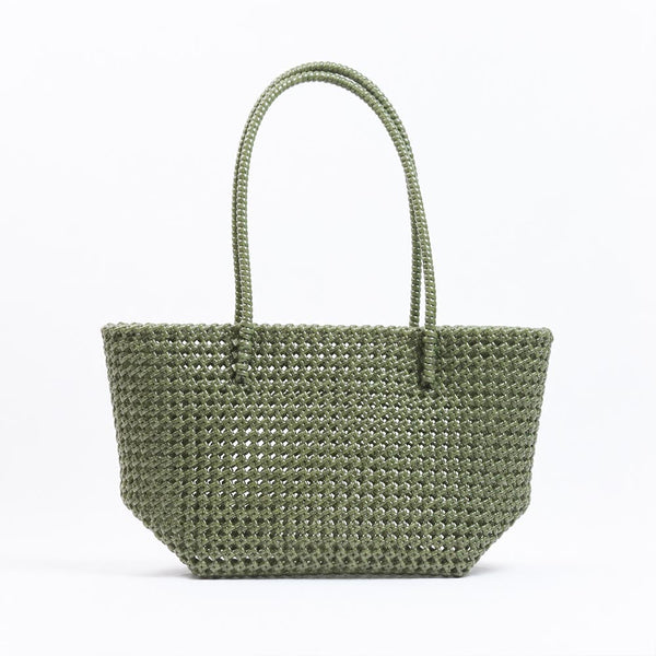Kalapuri handmade olive green Koodai tote bag on wooden stool with dried flowers