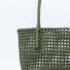 Woman carrying Kalapuri handwoven olive green Koodai tote bag outdoors