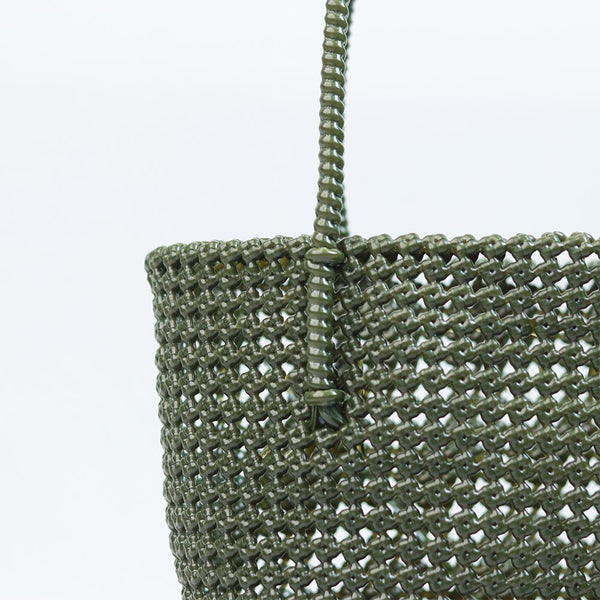 Woman carrying Kalapuri handwoven olive green Koodai tote bag outdoors
