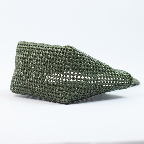 Close-up of woman holding Kalapuri olive green Koodai tote bag handle