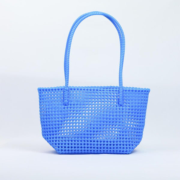 Kalapuri handmade cornflower blue Koodai tote bag on wooden stool with dried flowers