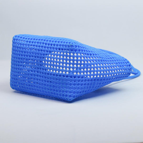 Close-up of woman holding Kalapuri cornflower blue Koodai tote bag handle