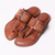 Pair of brown sandals with decorative straps on a white background