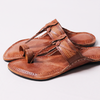 Pair of brown sandals on a light gray background