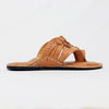 Brown sandal with detailed design on a white background